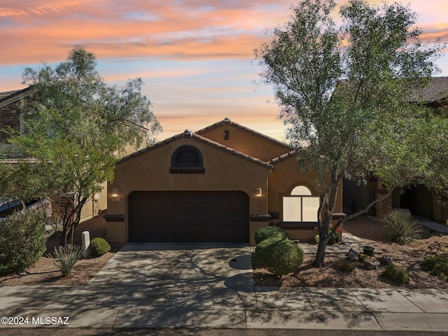 mediterranean / spanish-style home with a garage