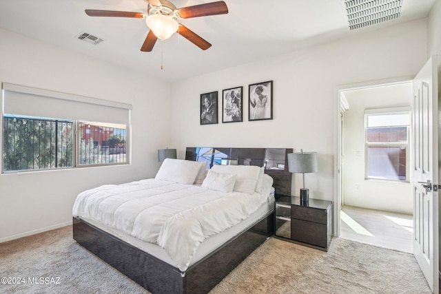 bedroom with light colored carpet and ceiling fan