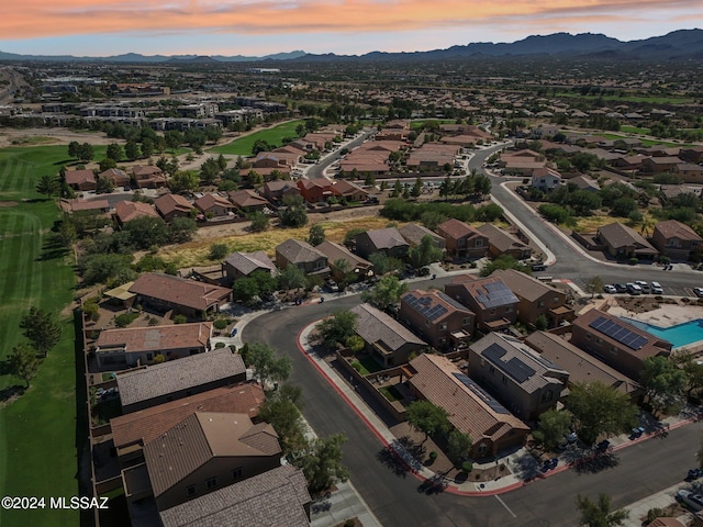 aerial view at dusk featuring a mountain view