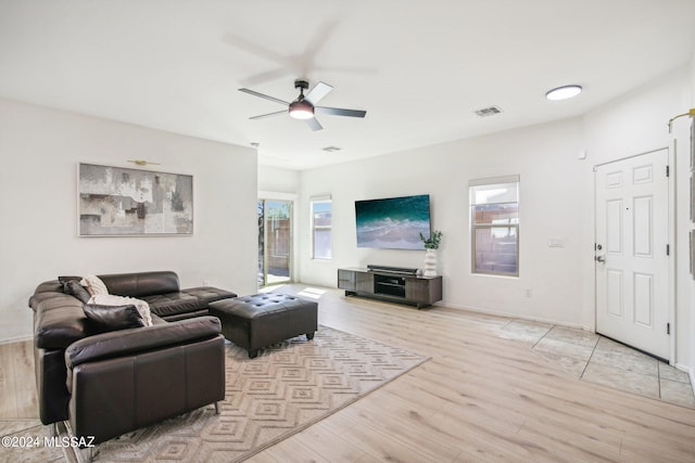 living room with light wood-type flooring and ceiling fan