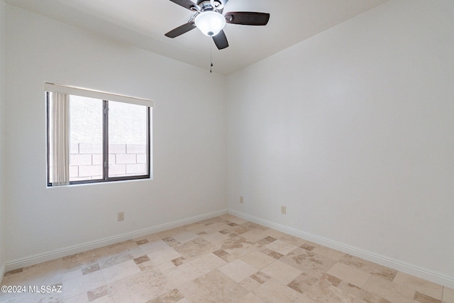 spare room with baseboards and ceiling fan