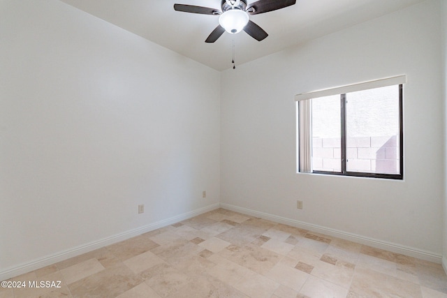 unfurnished room with vaulted ceiling, a ceiling fan, and baseboards
