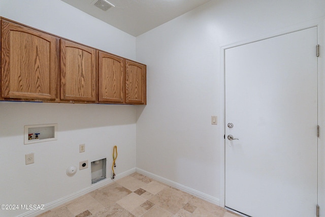 washroom featuring baseboards, washer hookup, hookup for a gas dryer, cabinet space, and electric dryer hookup