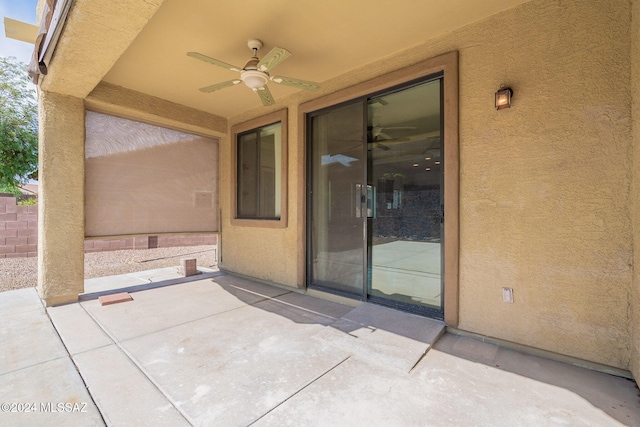 view of patio featuring fence and a ceiling fan