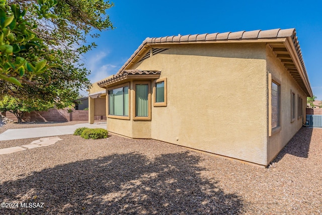 view of side of property with a patio