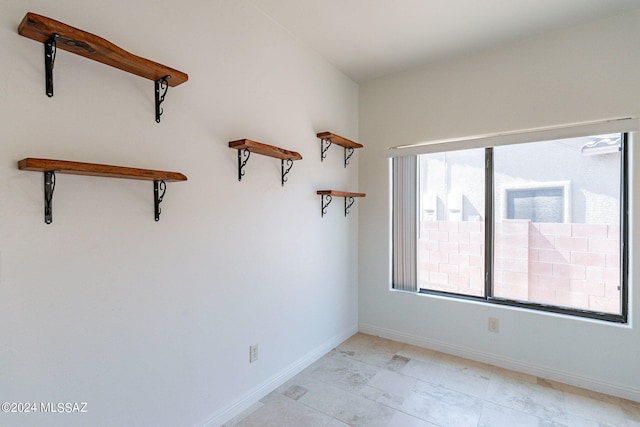 spare room featuring baseboards