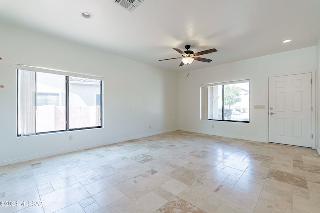 empty room with recessed lighting, visible vents, a ceiling fan, and baseboards
