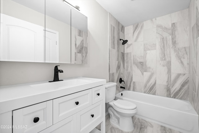 full bathroom featuring tiled shower / bath combo, vanity, and toilet