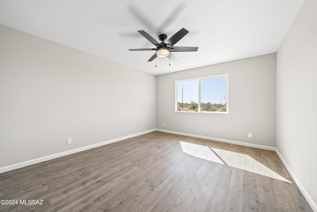 spare room with ceiling fan and hardwood / wood-style floors