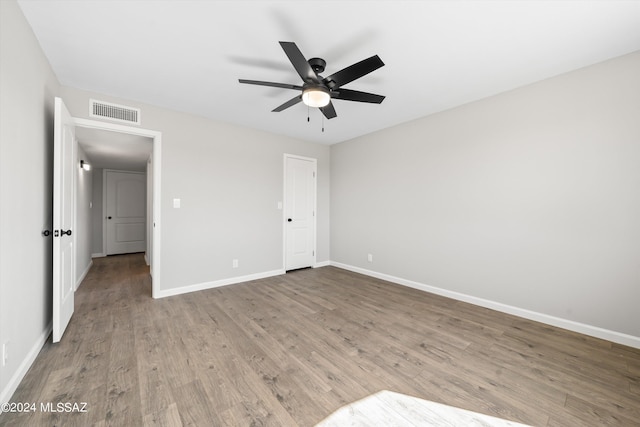 unfurnished bedroom with ceiling fan and wood-type flooring