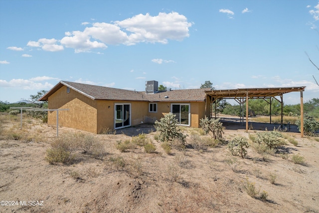 rear view of house featuring cooling unit and a patio area