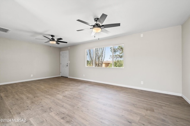 unfurnished room with hardwood / wood-style floors and ceiling fan