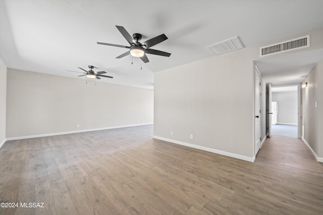 empty room with ceiling fan and hardwood / wood-style flooring