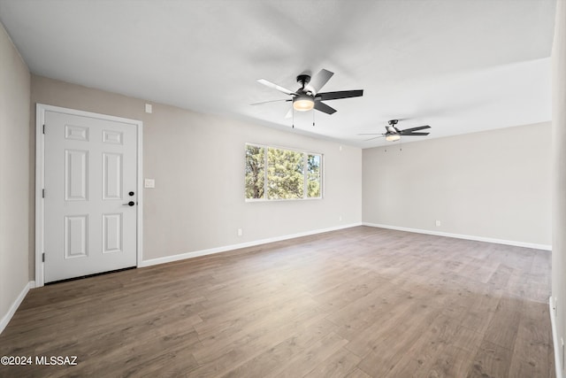 spare room featuring wood-type flooring and ceiling fan