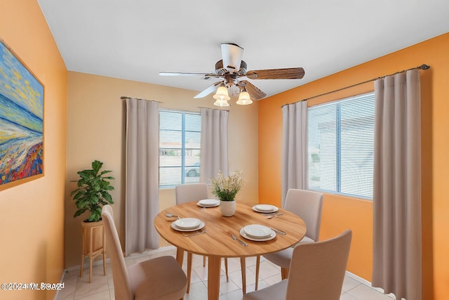 tiled dining area featuring ceiling fan