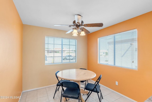 tiled dining area featuring ceiling fan