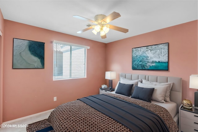 tiled bedroom with ceiling fan