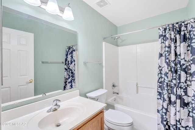 full bathroom featuring vanity, shower / bath combo with shower curtain, and toilet