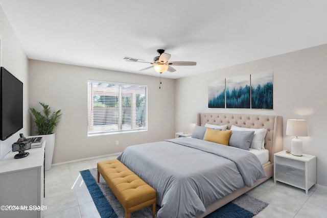 bedroom with ceiling fan and light tile patterned floors