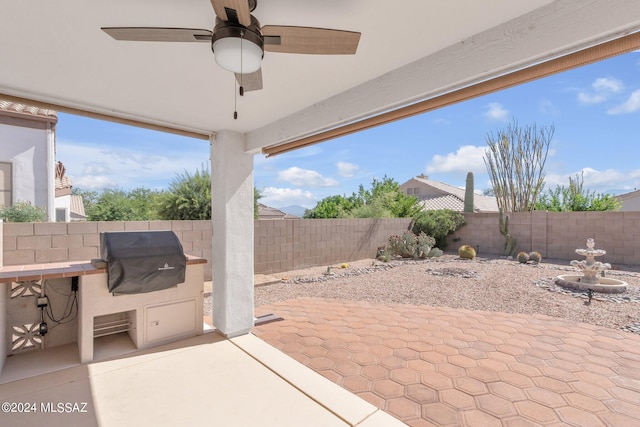 view of patio with ceiling fan and grilling area