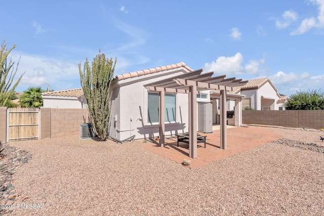 back of property with a pergola, central air condition unit, and a patio area