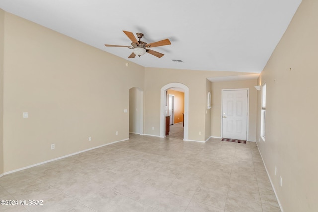 tiled spare room with ceiling fan