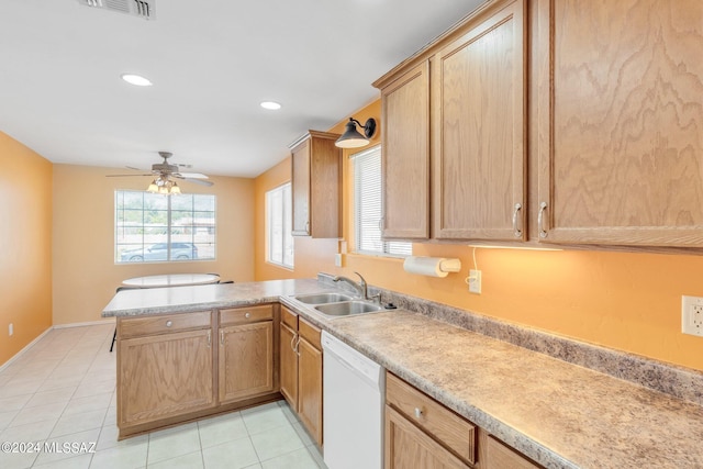 kitchen featuring sink, kitchen peninsula, light tile patterned floors, white dishwasher, and ceiling fan