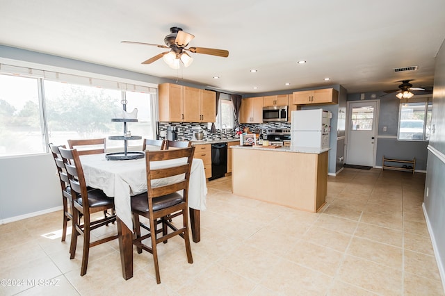 dining area with light tile patterned flooring and ceiling fan