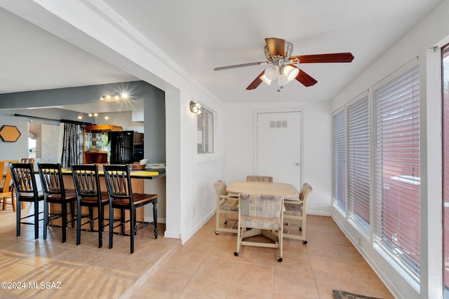 dining space with ceiling fan and light tile patterned floors