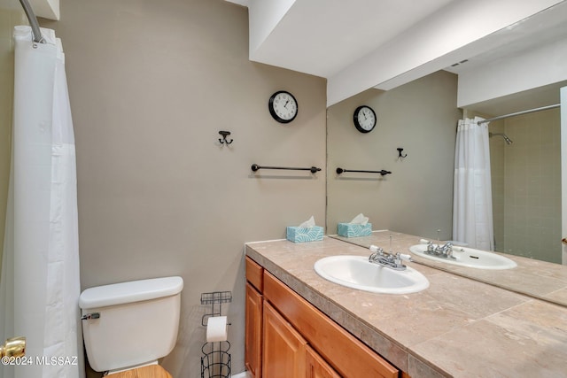 bathroom with vanity, toilet, and a shower with shower curtain