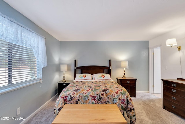 bedroom featuring light carpet