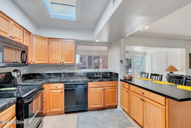 kitchen with black appliances, sink, kitchen peninsula, a kitchen bar, and light tile patterned floors