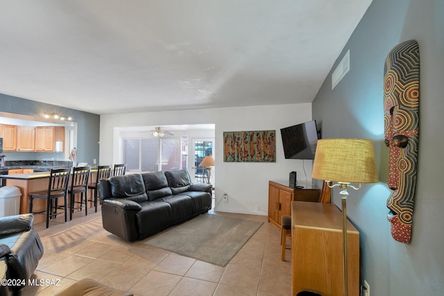 living room with light tile patterned flooring and ceiling fan