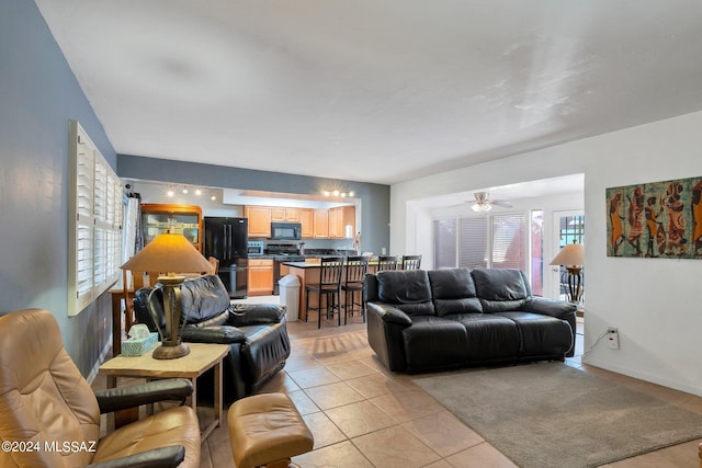 living room with light tile patterned floors and ceiling fan