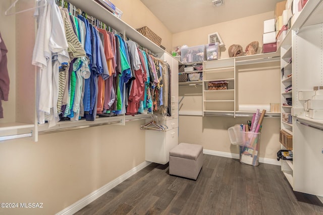 walk in closet with dark hardwood / wood-style flooring