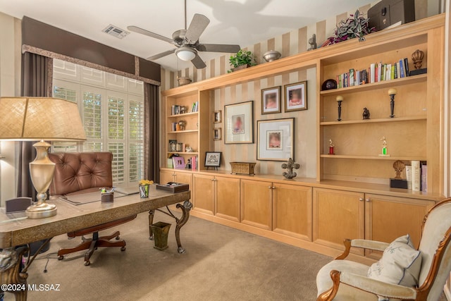 carpeted office space featuring ceiling fan