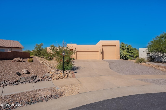 southwest-style home with a garage