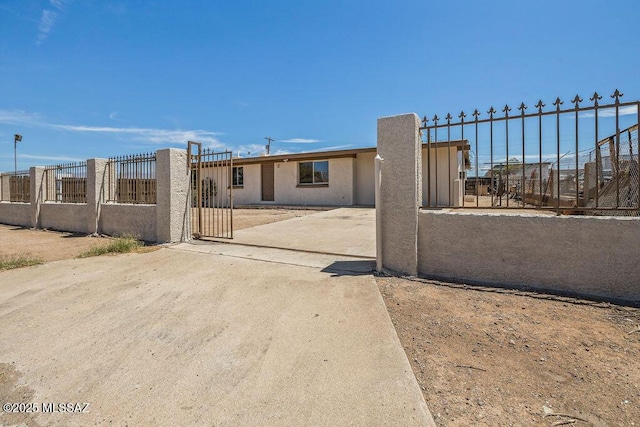 view of front facade featuring fence private yard and stucco siding
