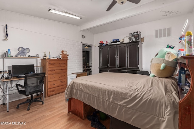 bedroom featuring ceiling fan, vaulted ceiling with beams, and light hardwood / wood-style floors