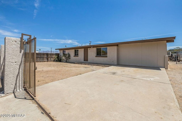 view of front of home with fence and a patio