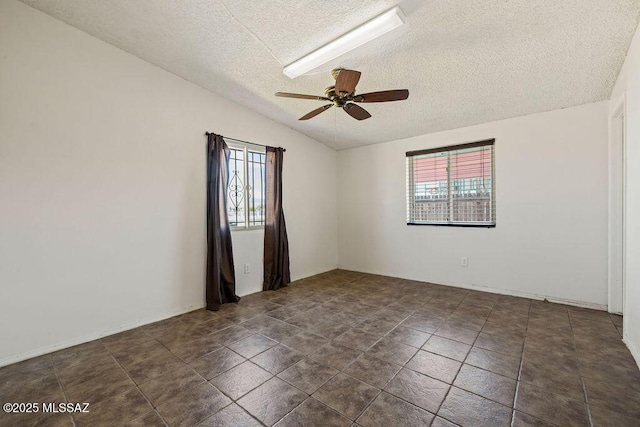 spare room featuring a ceiling fan, a textured ceiling, and vaulted ceiling