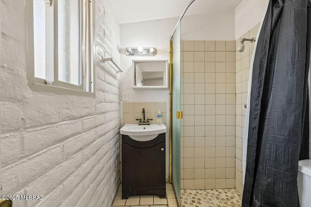full bathroom with toilet, vanity, and a shower stall