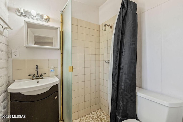 bathroom with a stall shower, toilet, and vanity