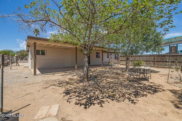 rear view of property with a patio area and fence