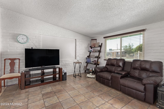 living room featuring brick wall, a textured ceiling, and vaulted ceiling