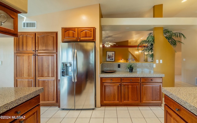 kitchen with stainless steel fridge with ice dispenser, light tile patterned floors, ceiling fan, and vaulted ceiling