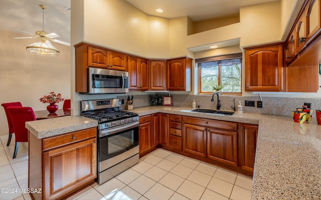 kitchen with high vaulted ceiling, sink, ceiling fan, light tile patterned floors, and appliances with stainless steel finishes