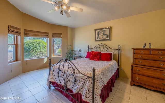 tiled bedroom with ceiling fan and lofted ceiling