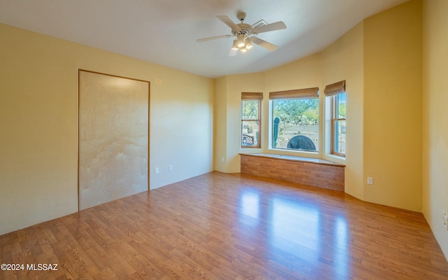 unfurnished bedroom with ceiling fan, light hardwood / wood-style floors, and a closet