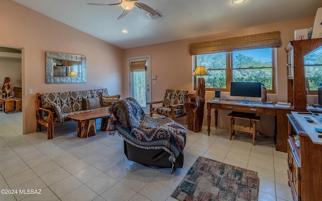 living room with ceiling fan, light tile patterned floors, and vaulted ceiling